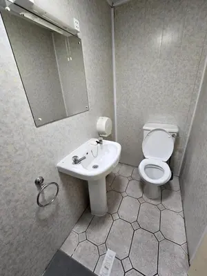a bathroom with a toilet and a sink at Wilsons Lodge in Blackpool