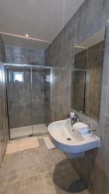 a bathroom with a sink and a shower at Hotel Blackpool in Blackpool
