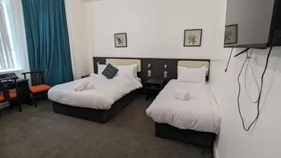 a hotel room with two beds and a television at Hotel Blackpool in Blackpool