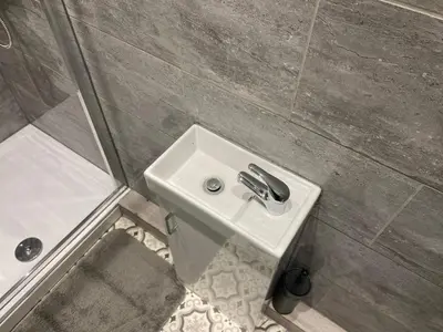 a bathroom with a sink and a shower at Stylish Home - Close to City Centre, Anfield Stadium - Free Parking in Litherland