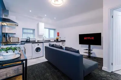a living room with a couch and a kitchen at Rocky Lane Urban Apartments by Charming Apartments - Flat 5 in Liverpool