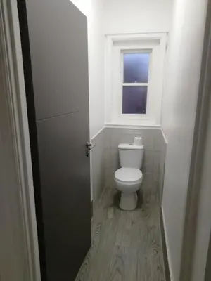 a small bathroom with a toilet and a window at Single Room Shared bathroom Free Street Parking Near Anfield LFC in Liverpool