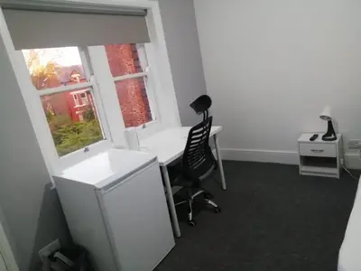 an office with a desk and a chair and a window at Single Room Shared bathroom Free Street Parking Near Anfield LFC in Liverpool