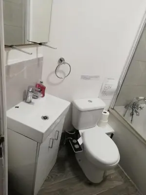 a white bathroom with a toilet and a sink at Single Room Shared bathroom Free Street Parking Near Anfield LFC in Liverpool
