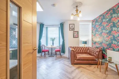 a living room with a couch and a table at Beautifully Designed 1 Bed Flat in Morecambe