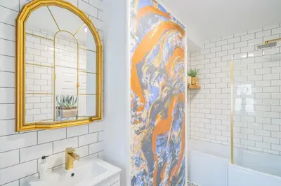 a bathroom with a shower with a sink and a mirror at Beautifully Designed 1 Bed Flat in Morecambe