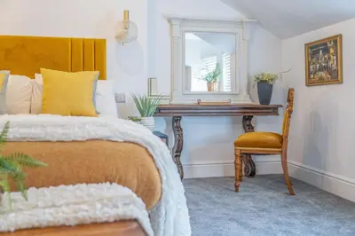 a bedroom with a bed and a desk and a chair at Gorgeous New 1 Bedroom Penthouse Flat in Morecambe