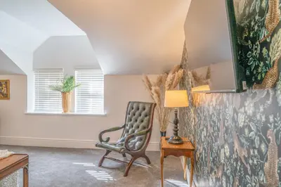 a living room with a chair and a lamp at Gorgeous New 1 Bedroom Penthouse Flat in Morecambe