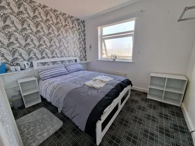 a bedroom with a bed and a window at Number 40 in Blackpool
