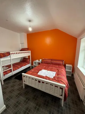 a bedroom with two bunk beds and an orange wall at Number 40 in Blackpool
