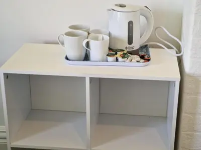 a white table with cups and a tea pot on it at Number 40 in Blackpool