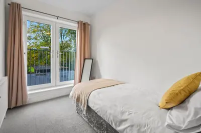 a bedroom with a bed and a window at LUXURIOUS HOLIDAY HOME Bolton in Bolton