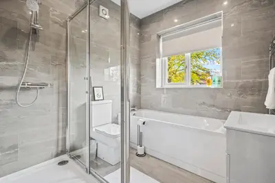 a bathroom with a shower and a toilet and a sink at LUXURIOUS HOLIDAY HOME Bolton in Bolton