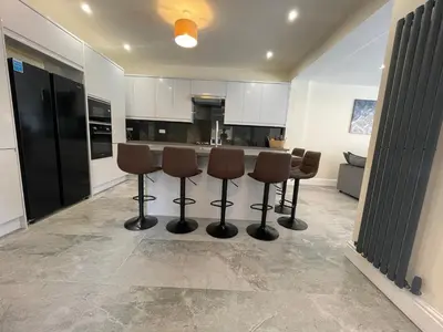 a kitchen with chairs and a counter in a room at LUXURIOUS HOLIDAY HOME Bolton in Bolton