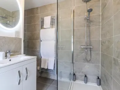 a bathroom with a shower and a sink at Stork Cottage in Lancaster