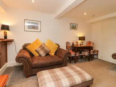 a living room with a couch and a table at Stork Cottage in Lancaster