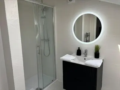 a bathroom with a sink and a shower with a mirror at Pilgrim House by Phoenix Collection in Liverpool