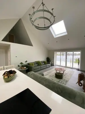 a living room with a couch and a chandelier at Luxurious and Peaceful Lakeside House, Clitheroe in Clitheroe