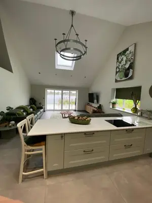 a kitchen with a island with a sink and a chandelier at Luxurious and Peaceful Lakeside House, Clitheroe in Clitheroe