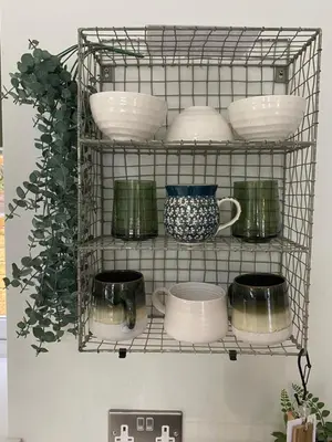 a wire shelf with dishes and bowls on it at Luxurious and Peaceful Lakeside House, Clitheroe in Clitheroe
