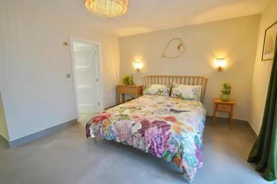a bedroom with a bed with a colorful bedspread at Luxurious and Peaceful Lakeside House, Clitheroe in Clitheroe
