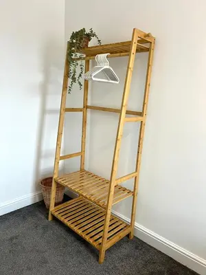 a wooden ladder shelf against a wall with a lamp at Quaint 2Bed House near Wigan Centre in Ince-in-Makerfield