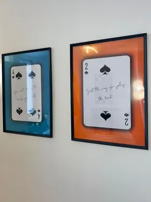 two framed pictures with writing on them on a wall at Quaint 2Bed House near Wigan Centre in Ince-in-Makerfield