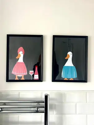two framed pictures of two ducks on a wall at Quaint 2Bed House near Wigan Centre in Ince-in-Makerfield