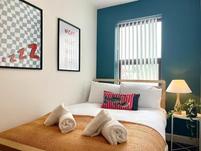 a bedroom with a bed with towels on it at Quaint 2Bed House near Wigan Centre in Ince-in-Makerfield