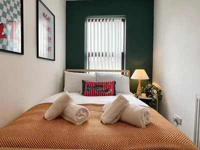 a bedroom with a bed with two pillows on it at Quaint 2Bed House near Wigan Centre in Ince-in-Makerfield