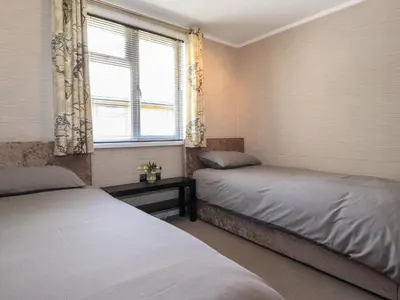two beds sitting in a room with a window at Capenwray in Carnforth