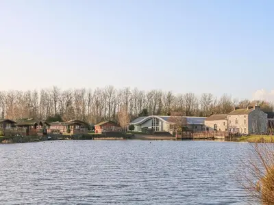 a view of a lake with houses and buildings at Capenwray in Carnforth