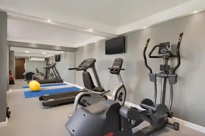a gym with several treadmills and cardio machines at Ramada Chorley South in Chorley