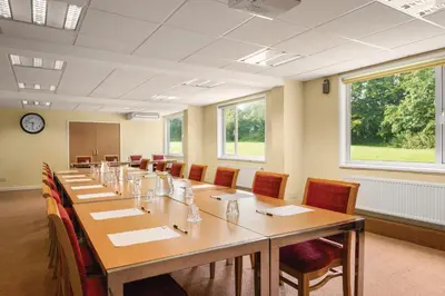 a large conference room with a long table and chairs at Ramada Chorley South in Chorley