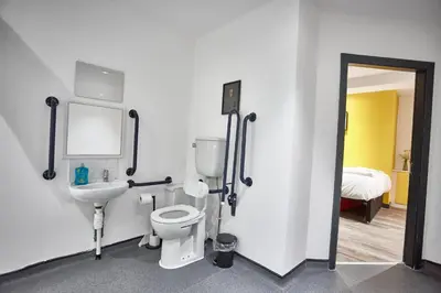 a bathroom with a toilet and a sink at LENNON SUITE 4 Bedrooms, 4 Bathrooms in Liverpool