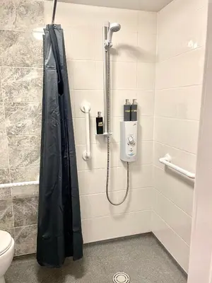 a shower with a black shower curtain in a bathroom at Beautiful Entire House! in Liverpool