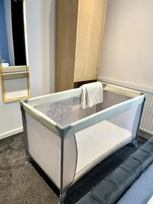 a bed in a room with a mirror at Beautiful Entire House! in Liverpool