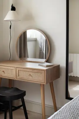 a dressing table with a mirror next to a bed at Drakes Cottage in Cartmel