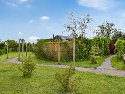 a garden with a fence and a path at Laurel Pod - Uk47203 in Westhead