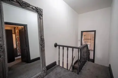 a mirror in a hallway with a stairway with a mirrorigunigunigunigun at Spacious Town House in Lytham St Annes