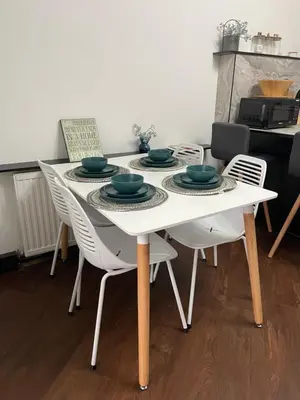 a white dining room table with four chairs and a table at Slick Space for a Standish Stay in Standish