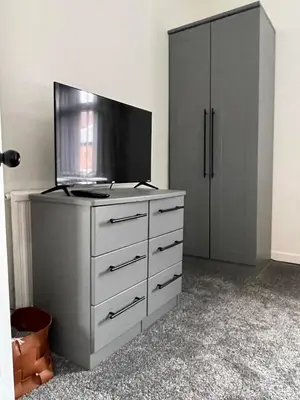 a dresser with a flat screen tv on top of it at Slick Space for a Standish Stay in Standish