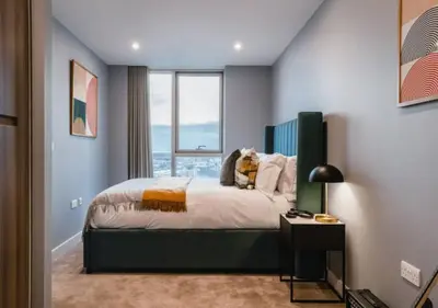 a bedroom with a bed and a large window at Charles Hope Liverpool in Liverpool