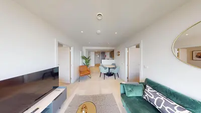 a living room with a green couch and a table at Charles Hope Liverpool in Liverpool