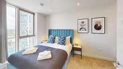 a bedroom with a large bed with two towels on it at Charles Hope Liverpool in Liverpool