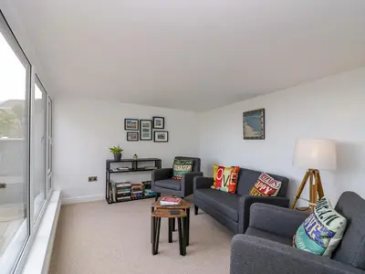 a living room with two couches and a table at Brynmar in Morecambe