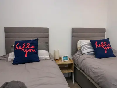 two beds sitting next to each other in a room at Brynmar in Morecambe
