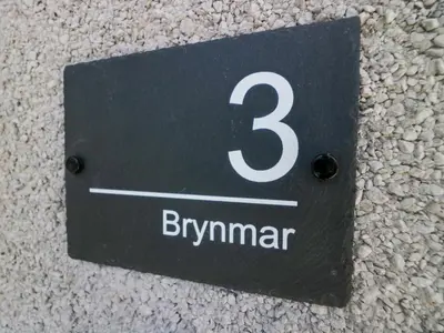 a sign with the number three on the wall at Brynmar in Morecambe