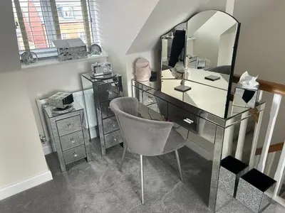 a glass desk with a chair and a mirror at Drey Close in Formby