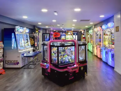 a video game arcade with several games in a room at Sea Breeze in Heysham